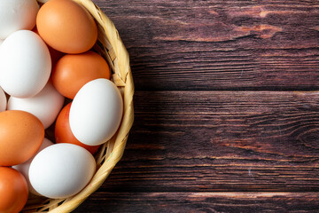 Brown and white eggs in a basket