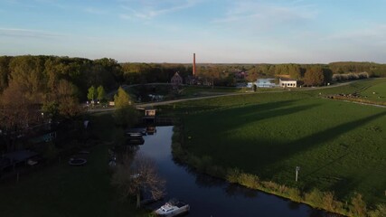 Appeltern, the Netherlands - April 19th 2025: Drone flying towards 'de Tuut' a historic steam pumping station, previously used for water management. 