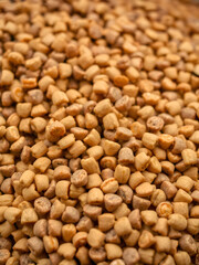 Fototapeta premium Close up shot of pet food kibble being processed, showcasing texture and detail. image captures dynamic flow of kibble, emphasizing quality