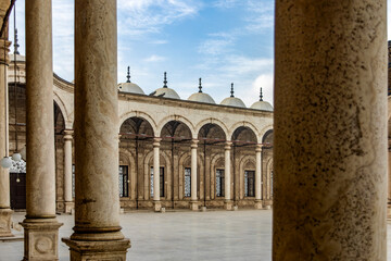 Present the courtyard columns of Mohammed Ali's Alabaster Mosque, highlighting Cairo's medieval...