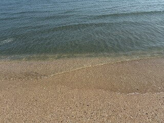 water, beach, sand, shoreline, ocean, sea, coast, nature, tranquil, peaceful, calm, serenity, clear water, wet sand, ripples, waves, gentle waves, shore, summer, travel, vacation, tropical, sunny, war