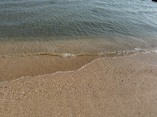 water, beach, sand, shoreline, ocean, sea, coast, nature, tranquil, peaceful, calm, serenity, clear water, wet sand, ripples, waves, gentle waves, shore, summer, travel, vacation, tropical, sunny, war