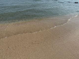 water, beach, sand, shoreline, ocean, sea, coast, nature, tranquil, peaceful, calm, serenity, clear water, wet sand, ripples, waves, gentle waves, shore, summer, travel, vacation, tropical, sunny, war