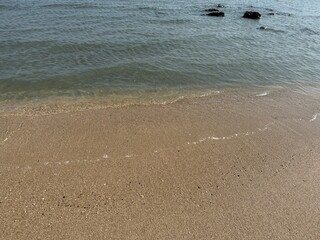water, beach, sand, shoreline, ocean, sea, coast, nature, tranquil, peaceful, calm, serenity, clear water, wet sand, ripples, waves, gentle waves, shore, summer, travel, vacation, tropical, sunny, war