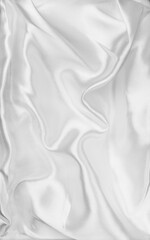Obraz premium White silk background, texture of beautiful white satin fabric close-up. Abstract smooth backdrop. Bridal vertical image design 