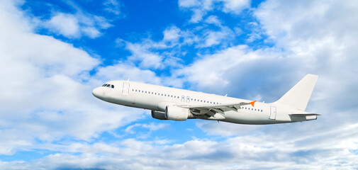 Airplane flying in the sky, white commercial airplane in the flight over the clouds, air travel landscape