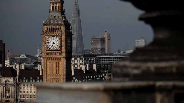 Rack focus from stone roof to legendary big ben in London - sunset