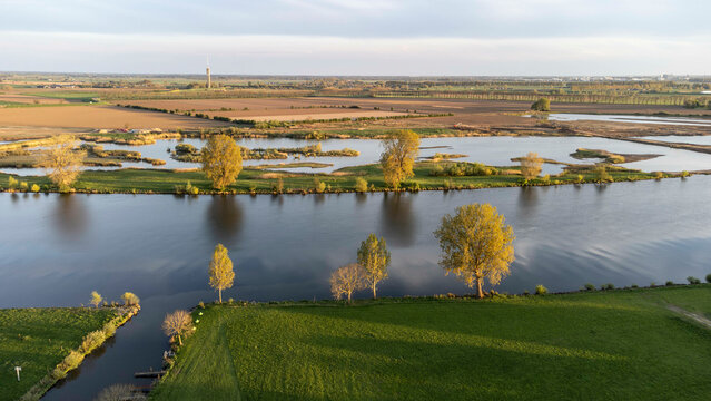 Appeltern, the Netherlands - April 19th 2025: View of the river Mesh. In the background a datatower can be seen from afar.