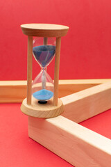 Hourglass with a flowing blue sand inside	