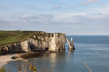 Fototapeta premium West coast of France. Clifs of Etreta. Rocks on the coast of the English channel strait. Etretat village, Normandy region.