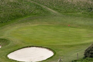 Golf course and red flag on a sunny day. Etretat France