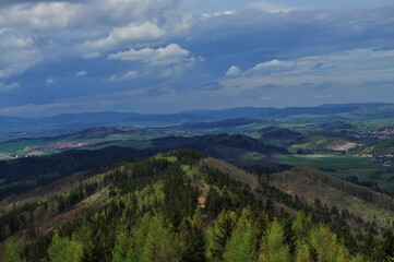 Naklejka premium Landscape of spring forest in the mountains and blue sky