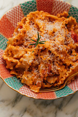 Mafalde noodles in sardine, tomato pasta sauce with rosemary and grated parmesan cheese