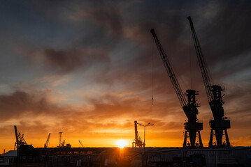 shipyard in szczecin city in poland with view of crane in operation at dawn © Sheviakova