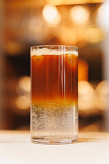 Non-alcoholic cocktails on bokeh background. Warm shades photo, multi-layered cocktails, drinks in beautiful glasses