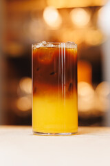 Non-alcoholic cocktails on bokeh background. Warm shades photo, multi-layered cocktails, drinks in beautiful glasses