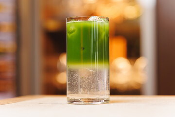 Non-alcoholic cocktails on bokeh background. Warm shades photo, multi-layered cocktails, drinks in beautiful glasses