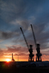 shipyard in szczecin city in poland with view of crane in operation at dawn