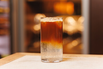 Non-alcoholic cocktails on bokeh background. Warm shades photo, multi-layered cocktails, drinks in beautiful glasses