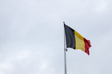 belgium flag belgian wave over a cloudy sky 