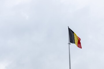 belgium flag belgian wave over a cloudy sky 