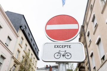 A bicycle street in Luxembourg with two road signs No entry, bicycles free and Bike street, each with a bicycle symbol. Old buildings in the background