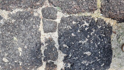 A dirt path paved with large stones, the stone courtyard of an ancient castle in Thailand, the floor of a castle in the past. Texture Image.