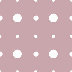 White polka dot print of different sizes on a light background Seamless vector pattern for any surfaces and the web.