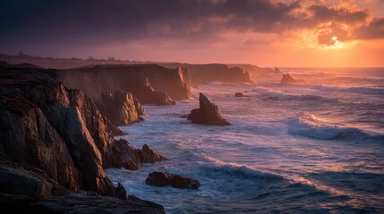 Dramatic sunset over rugged coastline, highlighting powerful waves.
