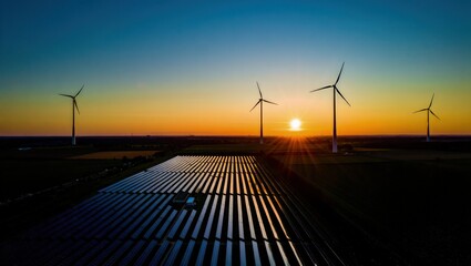 Windmill turbines generating green energy electric.Solar panels park and wind turbines at sunset.Green energy reduce carbon emissions and makes earth cleaner and more ecological.