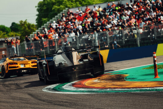 Sport racing prototype go fast at the race track fast during sunset