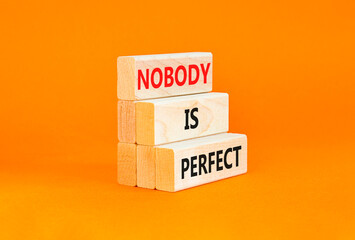 Nobody is perfect symbol. Concept words Nobody is perfect on beautiful wooden block. Beautiful orange table orange background. Business motivational lifestyle and nobody is perfect concept. Copy space