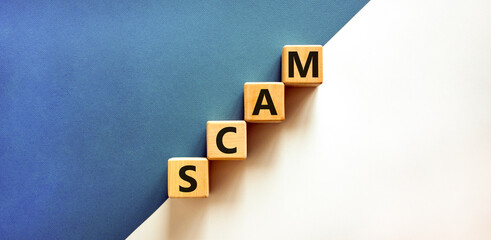 Obraz premium Scam symbol. Concept word Scam on beautiful wooden blocks. Beautiful white and blue background. Business, lifestyle, support and scam concept. Copy space.