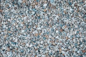 Colorful pebbles create a textured tapestry on a bright day in a serene outdoor setting, inviting exploration and peaceful reflection