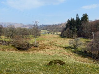 Peaceful Lake District meadow with distant fells in spring