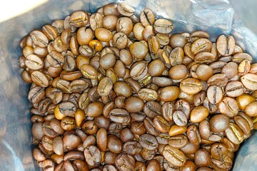 Freshly roasted coffee beans ready for brewing in a sealed bag for morning enjoyment