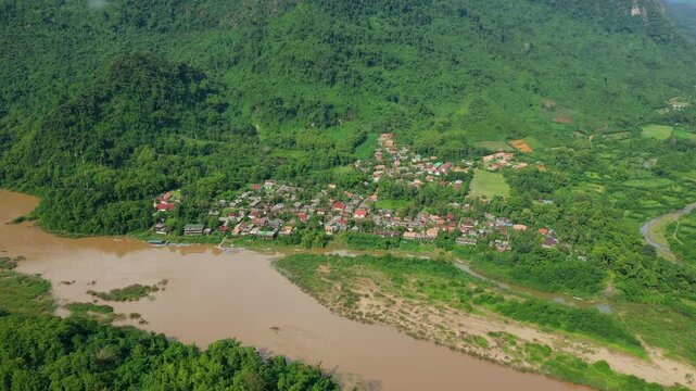 The Nam Ou River flowing through Muang Ngoi Neua in Asia, Laos, towards Luang Prabang, in summer on a sunny day.&nbsp;