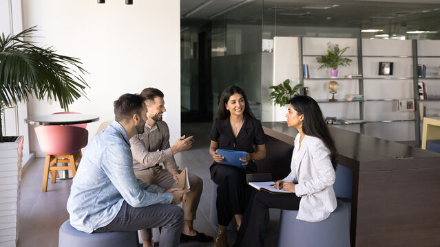 Employees gather in modern office space, engaged in interactive and collaborative discussion, smile, actively contributing to conversation during briefing, educational training event for staff members