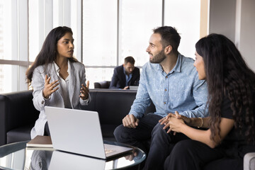 Manager explain contract or agreement details to couple met in modern office lobby. Teammates...
