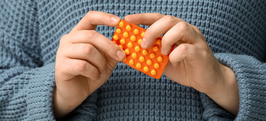 Man with pills in hands, closeup