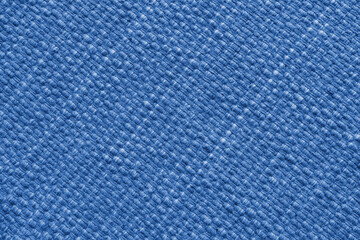 Texture of blue natural fabric with large diagonal weaving. Surface, structure of upholstery or carpet material, cloth background close up.