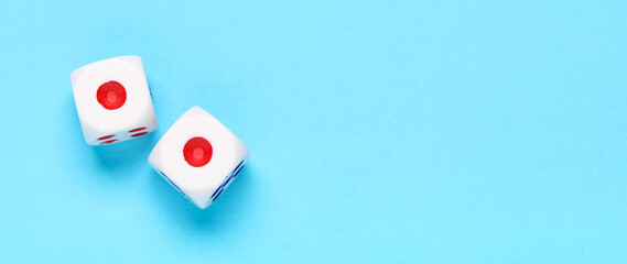 Dices with red and blue pips on blue background
