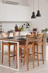 Interior of modern kitchen with served island table