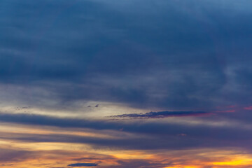 Colorful sunset with dynamic cloud formation in the evening sky