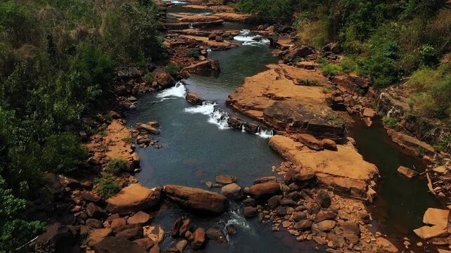 The winding river leading to Tad Tayicsua Falls in Asia, Laos, Champasak, on the Bolaven Plateau, on a sunny day.&nbsp;