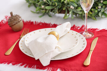 Beautiful Christmas table setting with dishes in kitchen, closeup