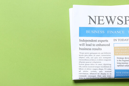 Modern newspaper on green background