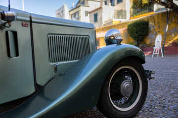 Close up to vintage car front side in the street of Funchal, Madeira island, Portugal.