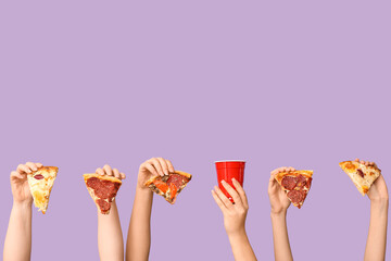 Many hands holding tasty pizza slices and one-use cup on lilac background