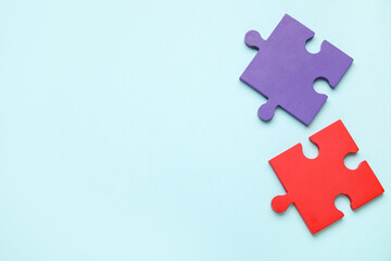 Obraz premium Colorful puzzle pieces on blue background. Concept of autistic disorder. Top view